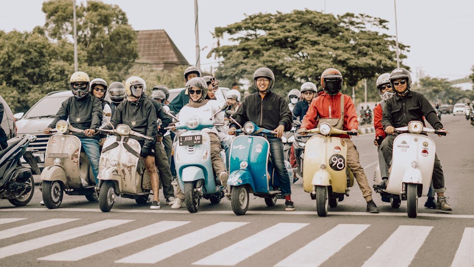 A vibrant group of scooter enthusiasts joyfully riding in East Java, Indonesia, showcasing camaraderie and culture.