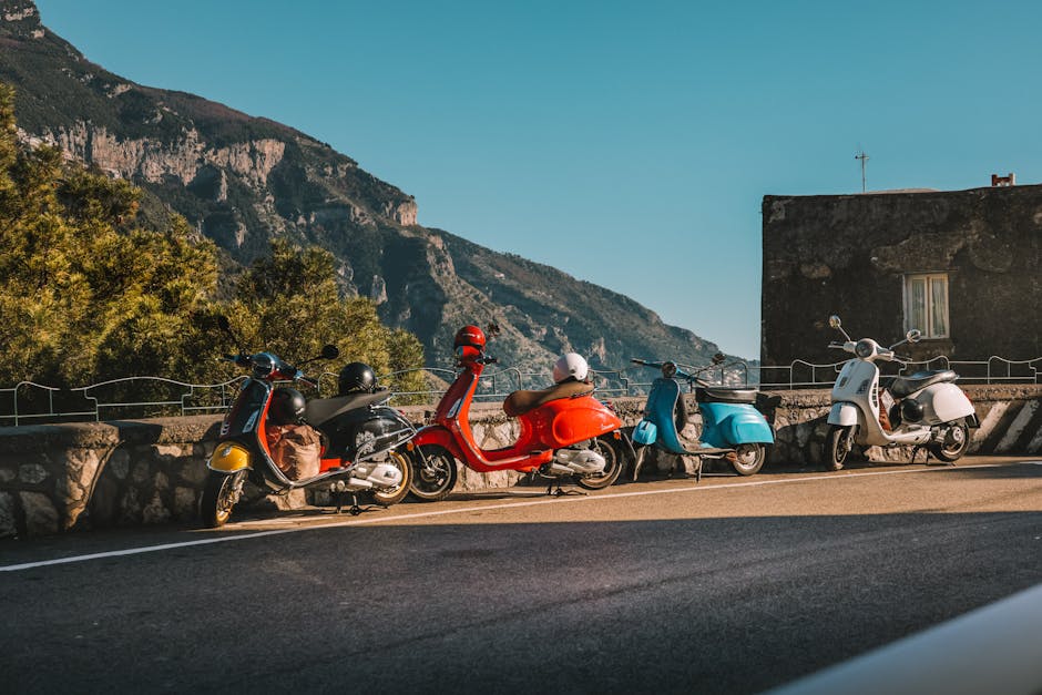 Vibrant scooters parked against a stunning mountain backdrop, perfect for travel inspiration.